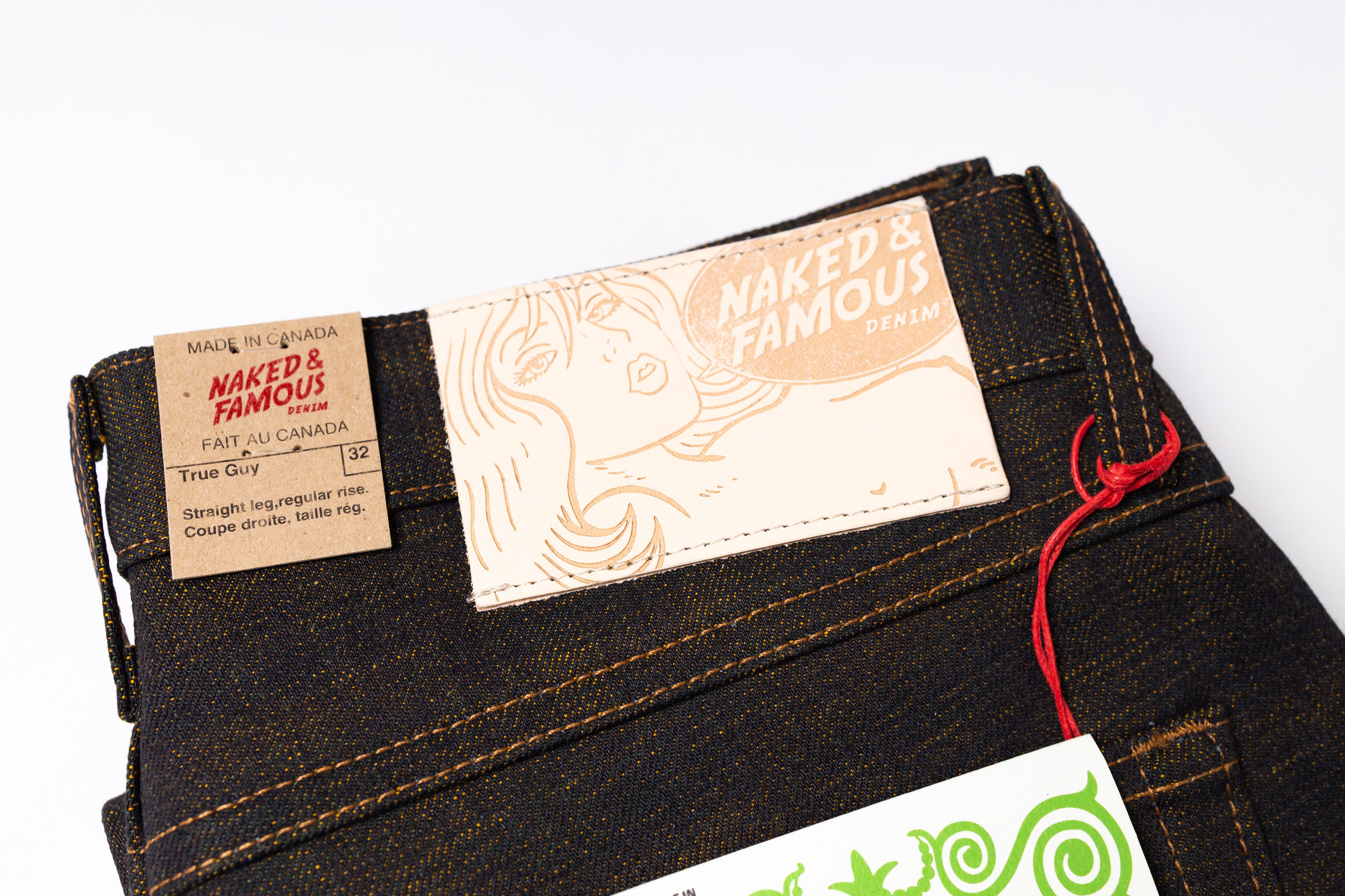 Folded jeans with a brand label on a white background
