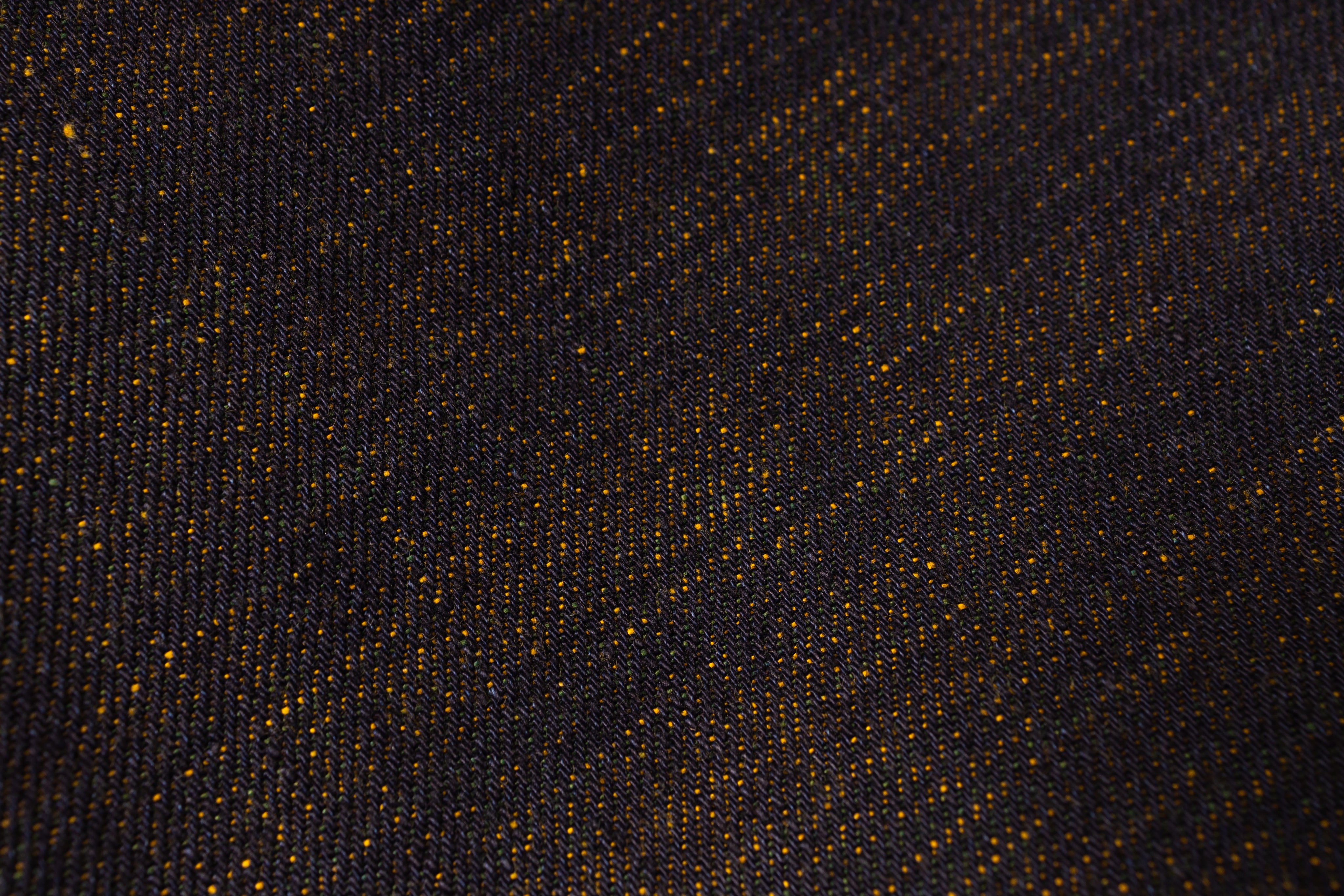 Close-up of a textured black fabric with gold specks