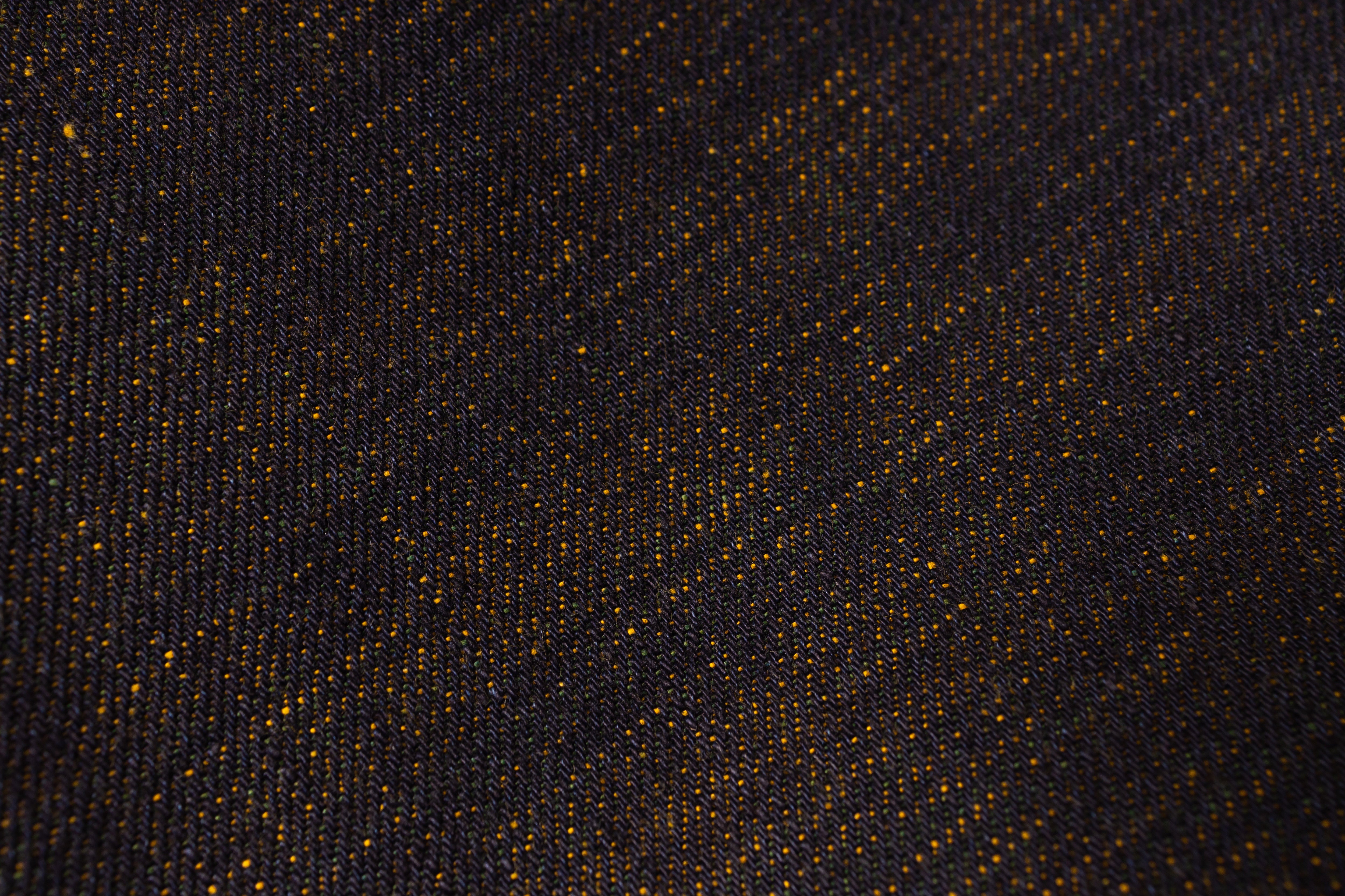 Close-up of a textured black fabric with gold specks