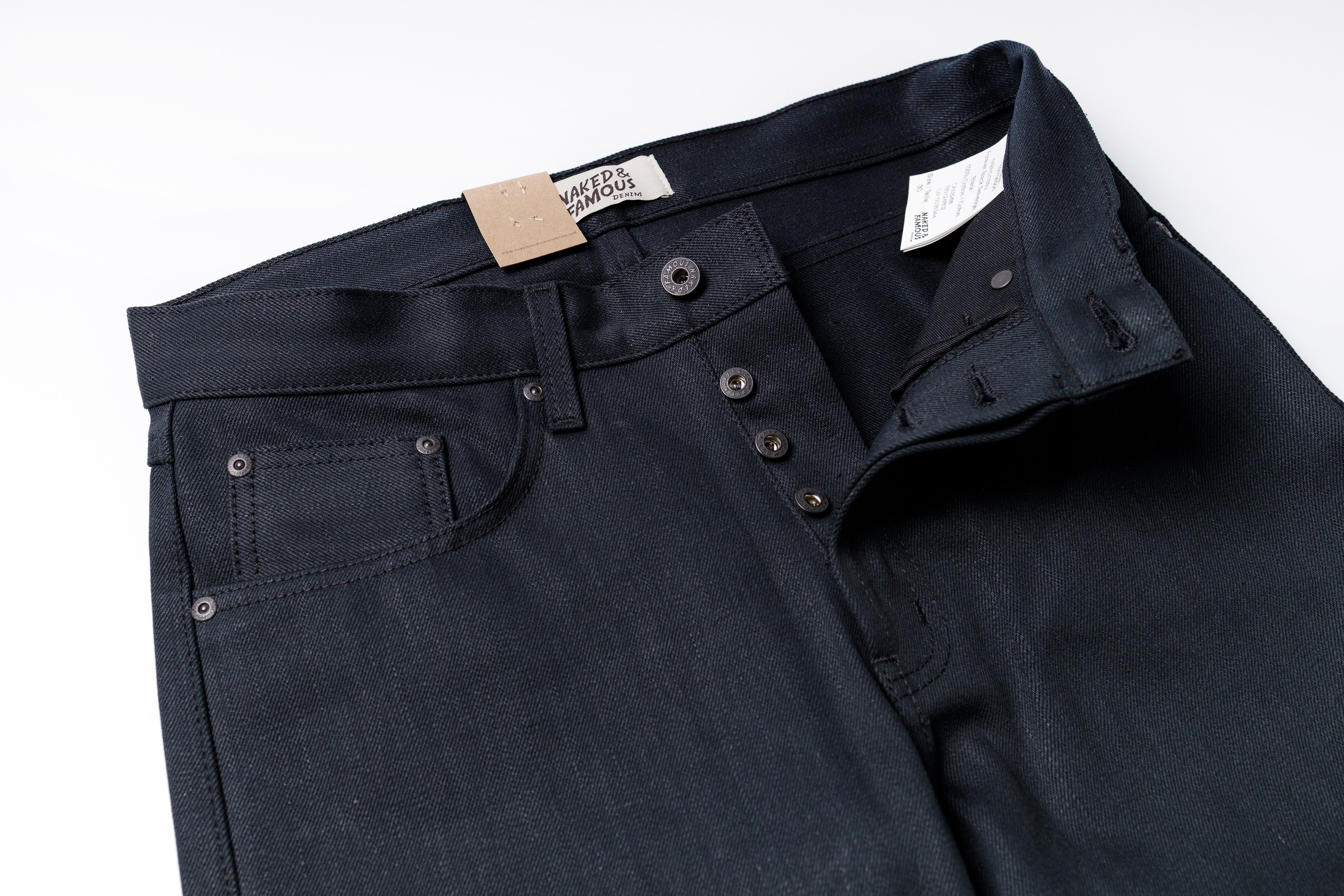 Dark blue jeans with a visible brand label on a white background