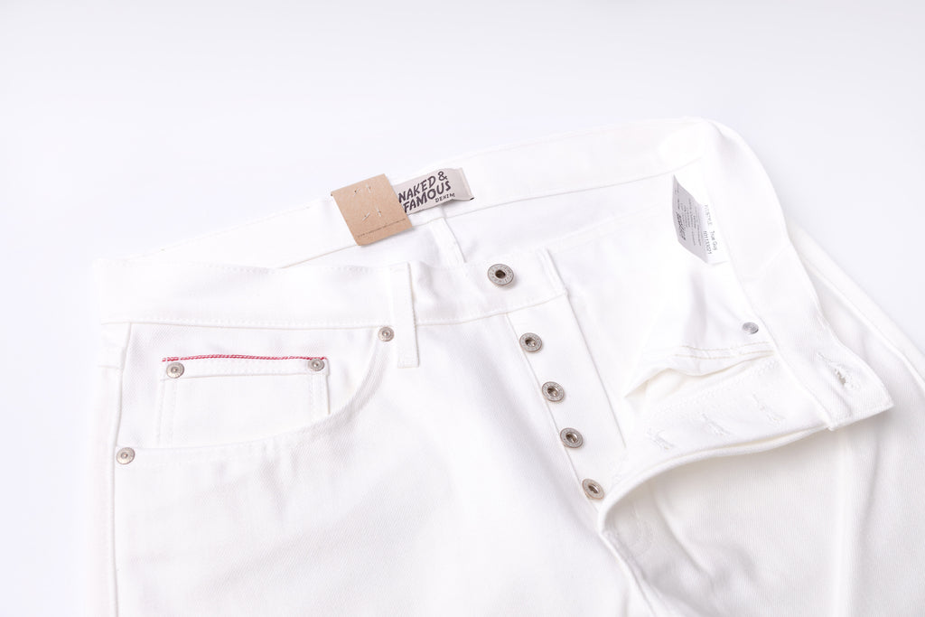 White denim jacket with a brand tag on a white background