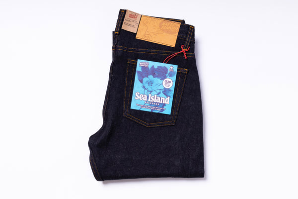 Folded pair of jeans with a visible brand label on a white background