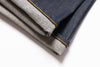 Two pairs of jeans, one dark blue and one gray, folded and placed on a white background.