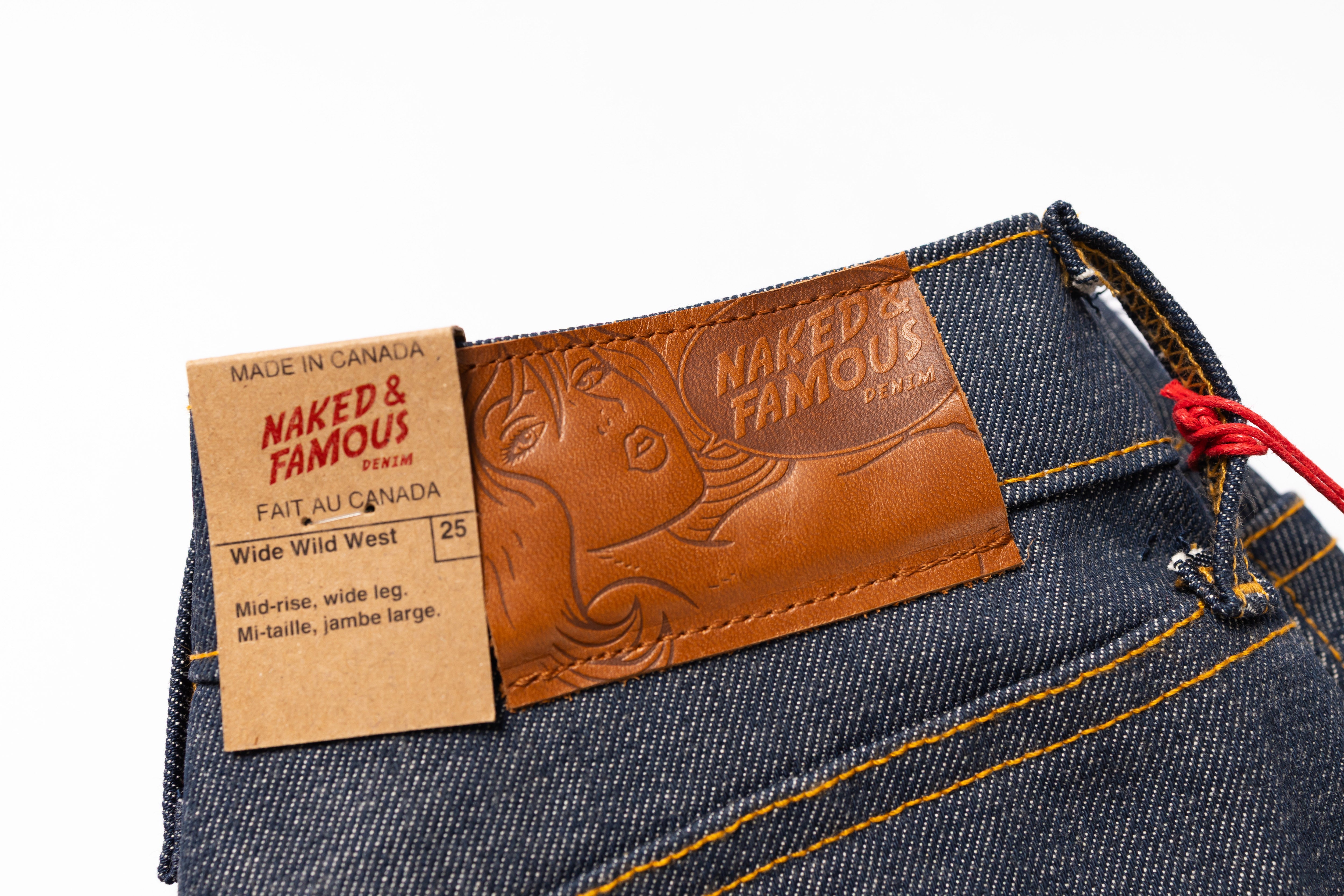 Close-up of a denim product with a 'Naked & Famous' label on a white background