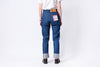 Person wearing blue jeans with a white background