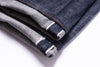 Close-up of folded denim fabric on a white background