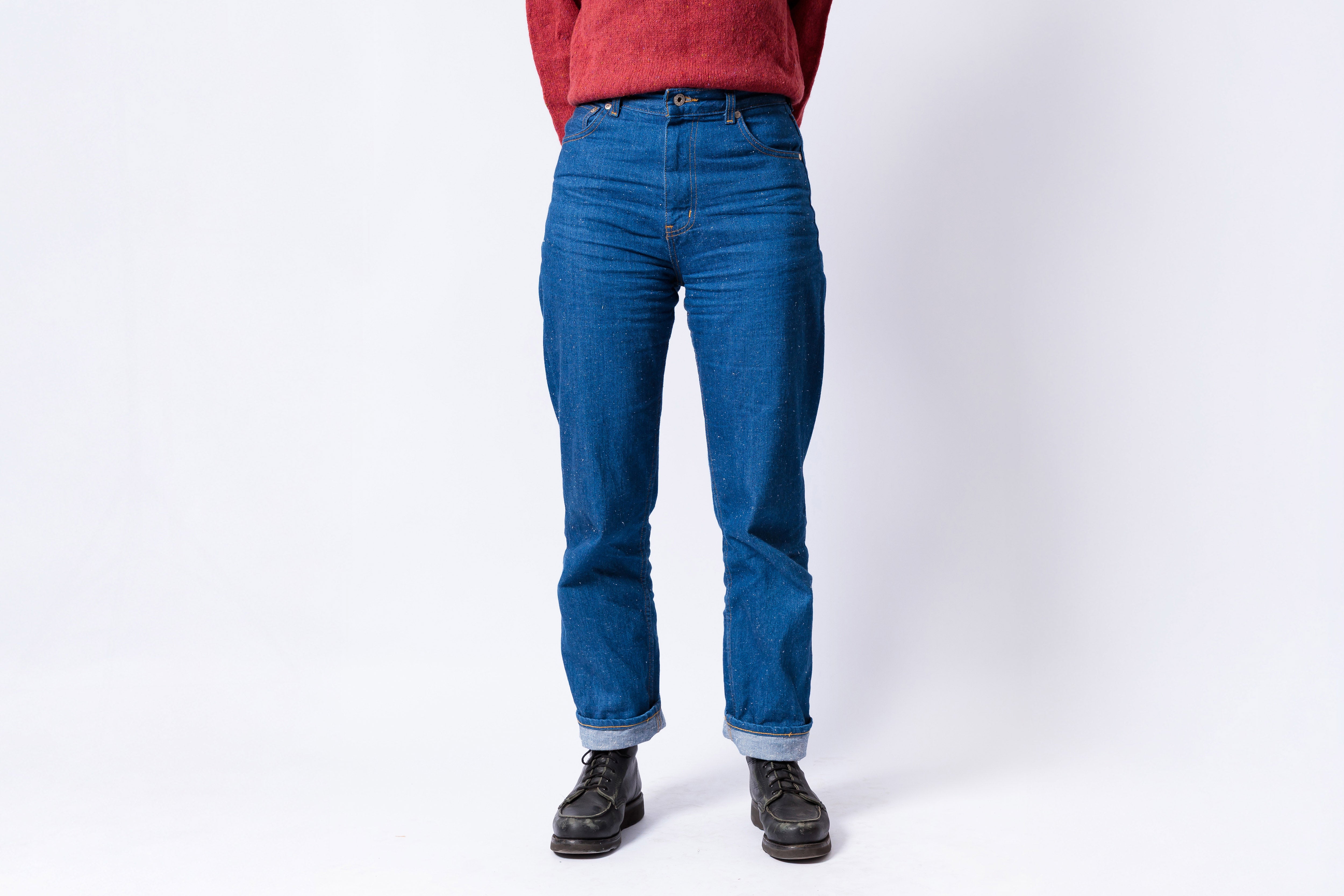 Person wearing blue jeans on a white background
