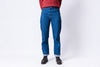 Person wearing blue jeans on a white background