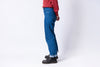 Person wearing blue jeans and a red shirt on a white background