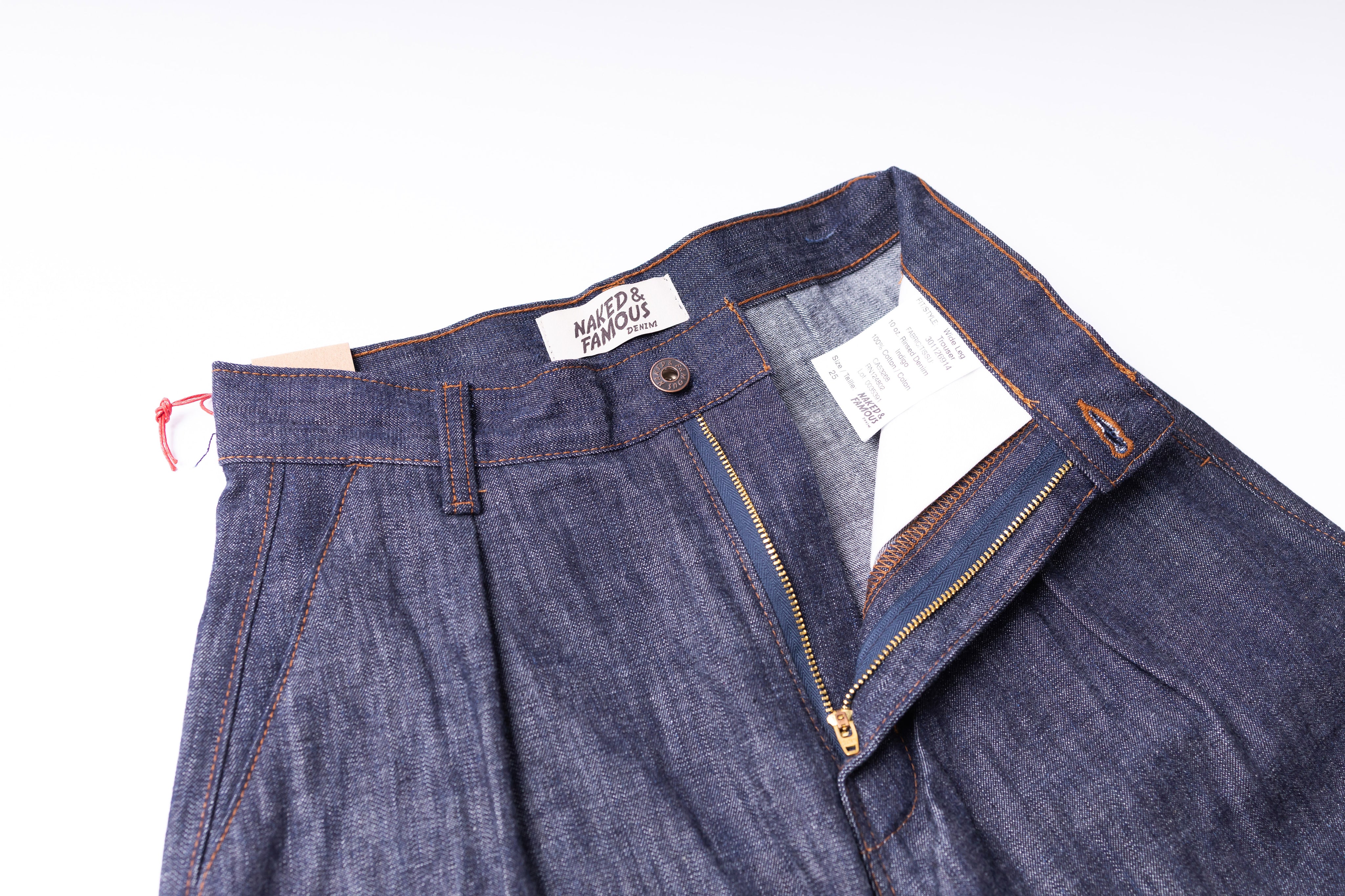 Blue denim pants with a brand label on a white background