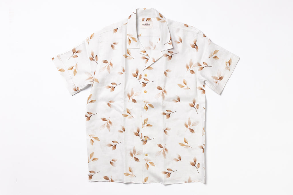 White shirt with brown leaf pattern on a white background