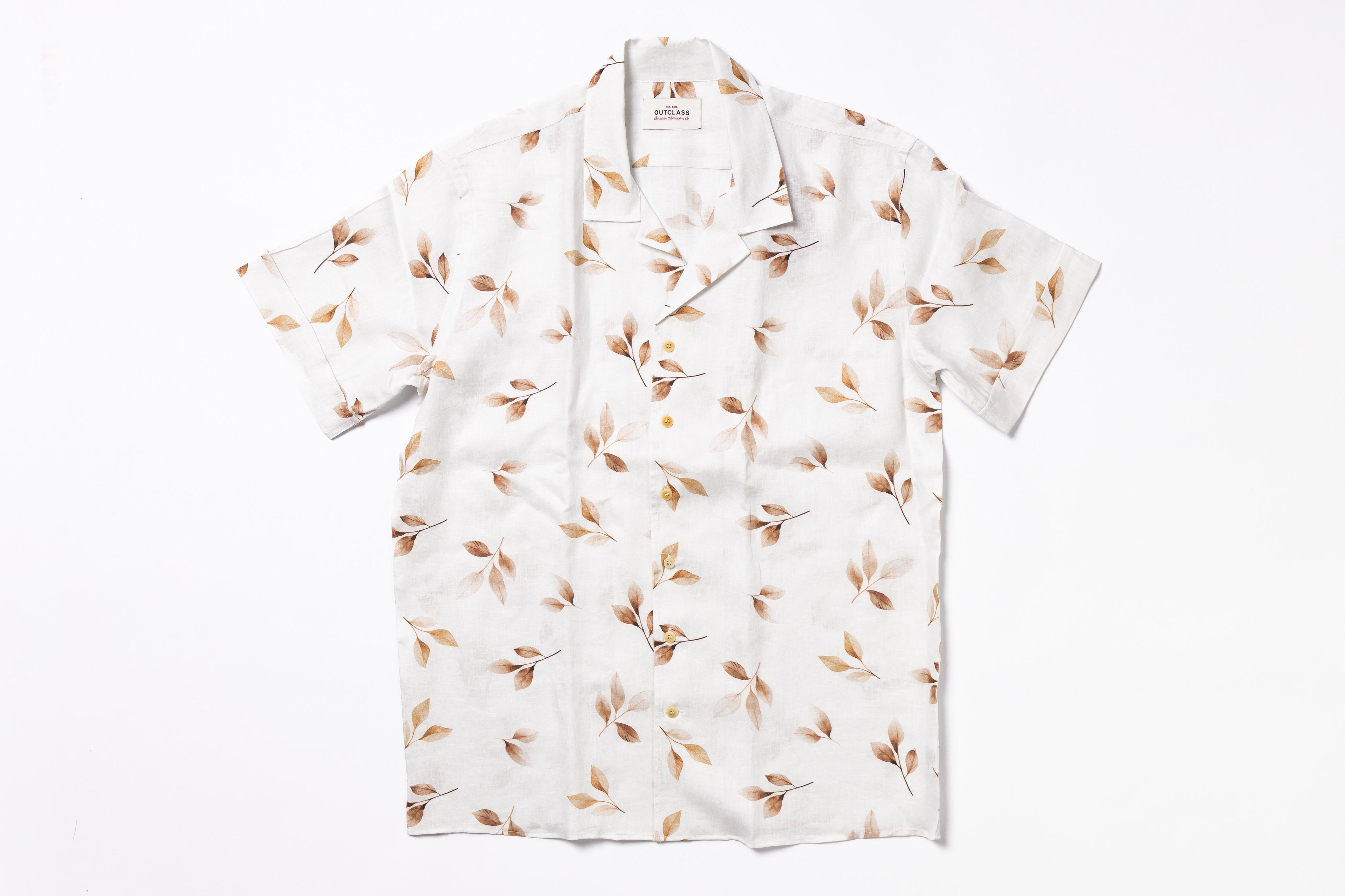 White shirt with brown leaf pattern on a white background