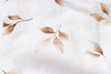 Close-up of fabric with brown leaf pattern on a white background