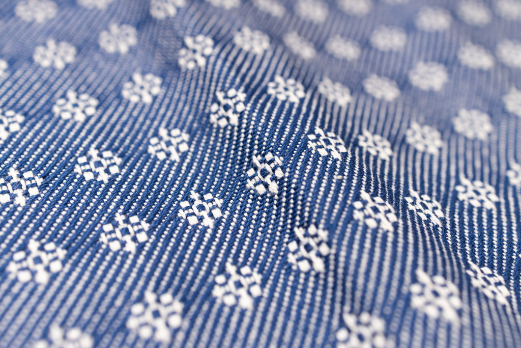Close-up of blue fabric with white floral pattern