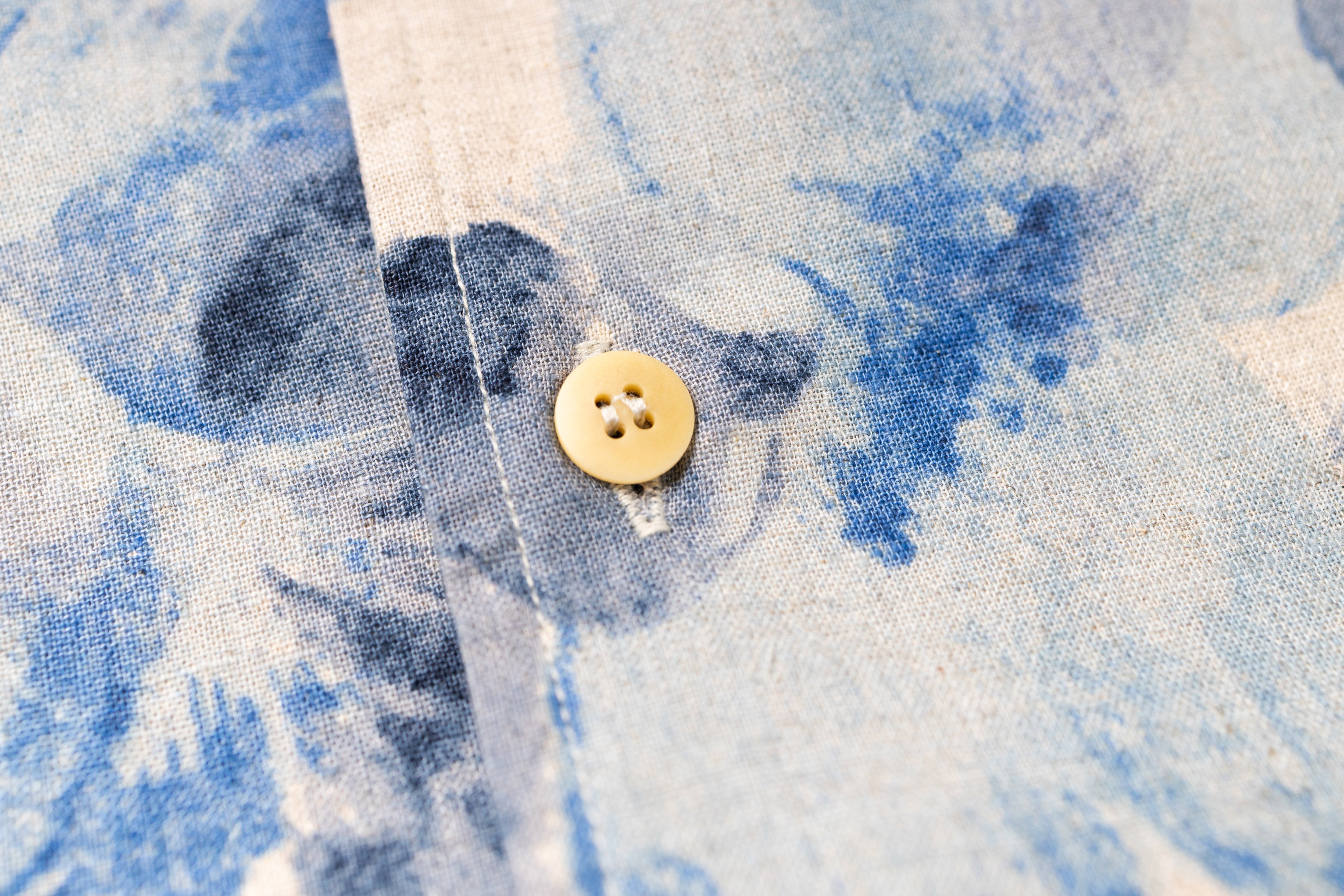 Close-up of a button on a blue and white fabric background