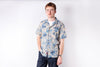 Man wearing a floral shirt on a white background
