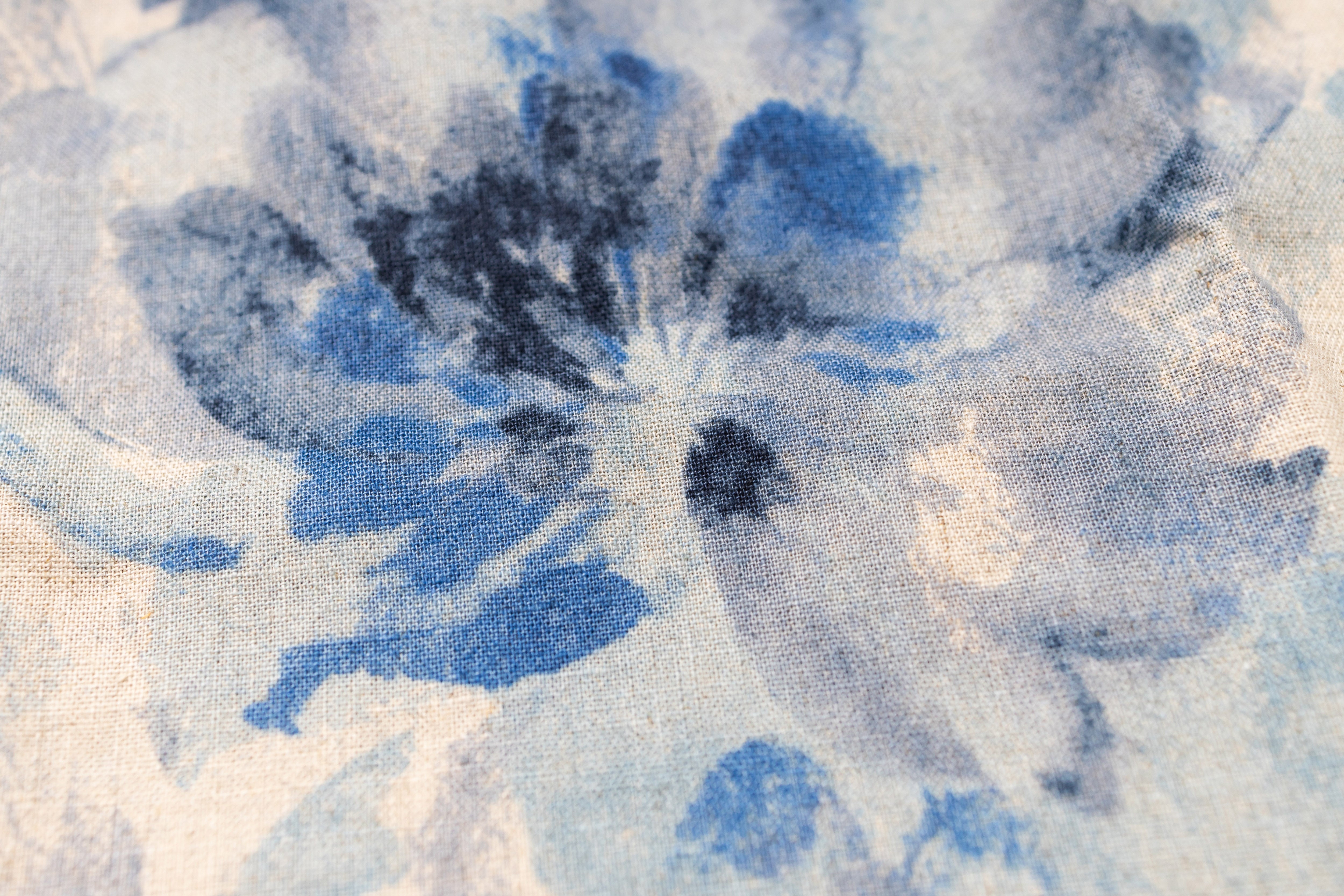 Close-up of a fabric with blue floral pattern on a white background