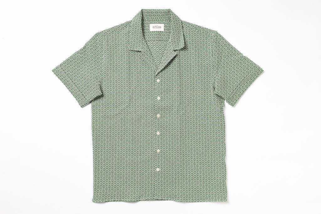 Green patterned shirt on a white background