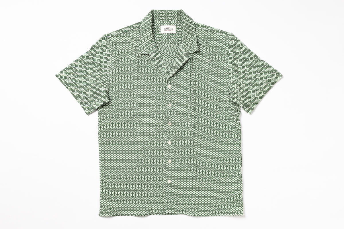 Green patterned shirt on a white background