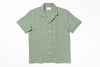 Green patterned shirt on a white background