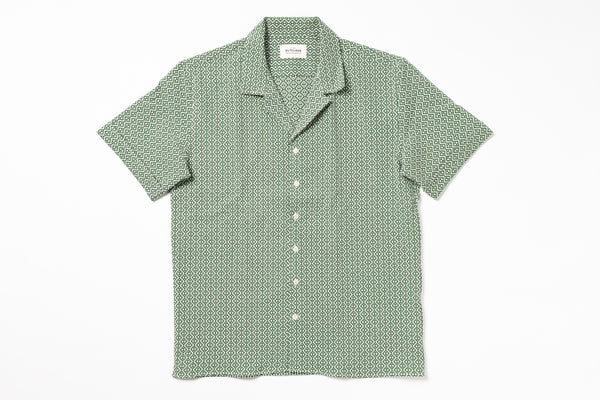 Green patterned shirt on a white background