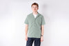 Man wearing a green checkered shirt against a white background