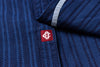 Close-up of a blue textured fabric with a red and white logo on a blue background