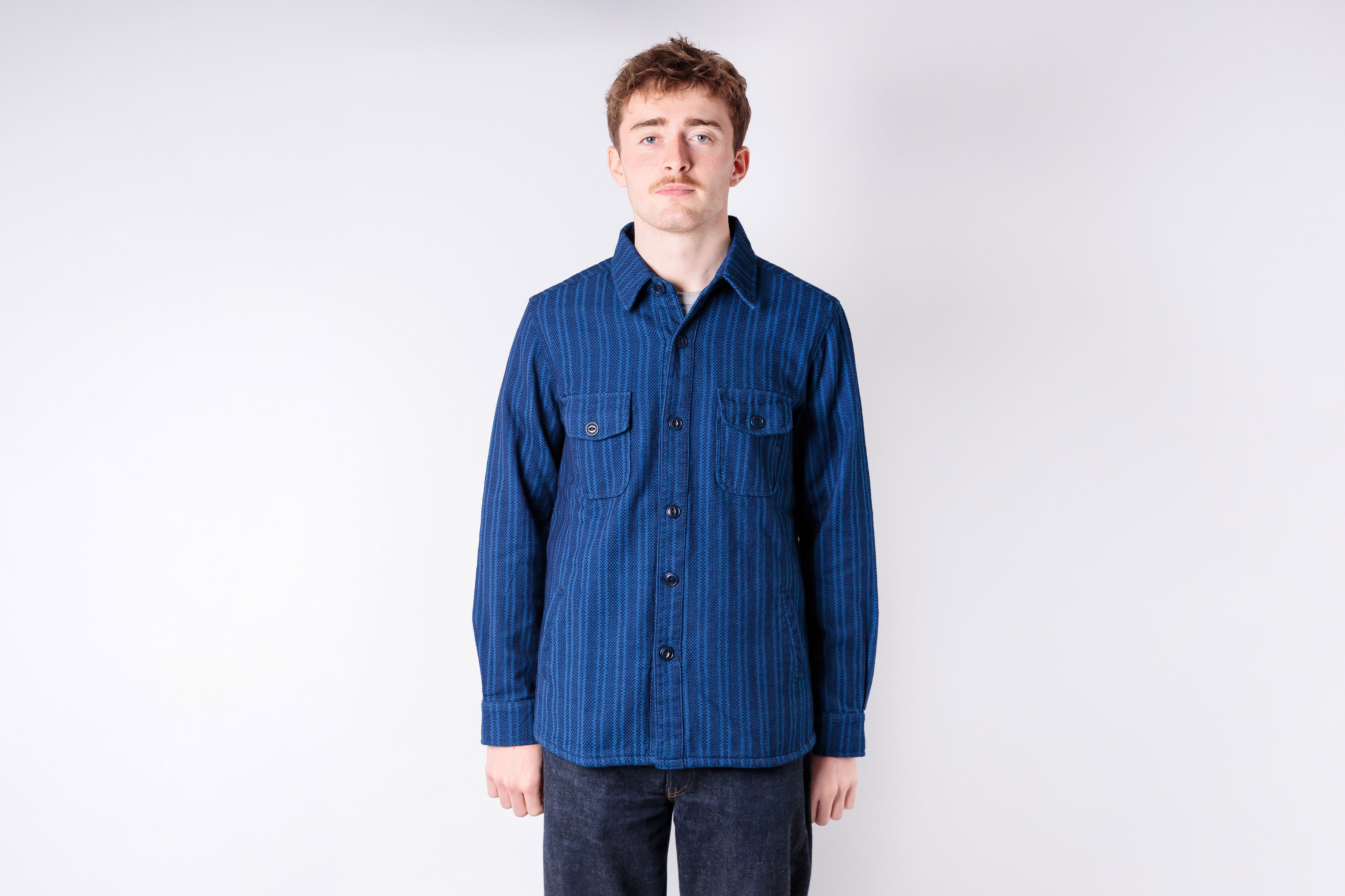 Person wearing a blue shirt against a white background