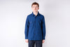 Person wearing a blue shirt against a white background