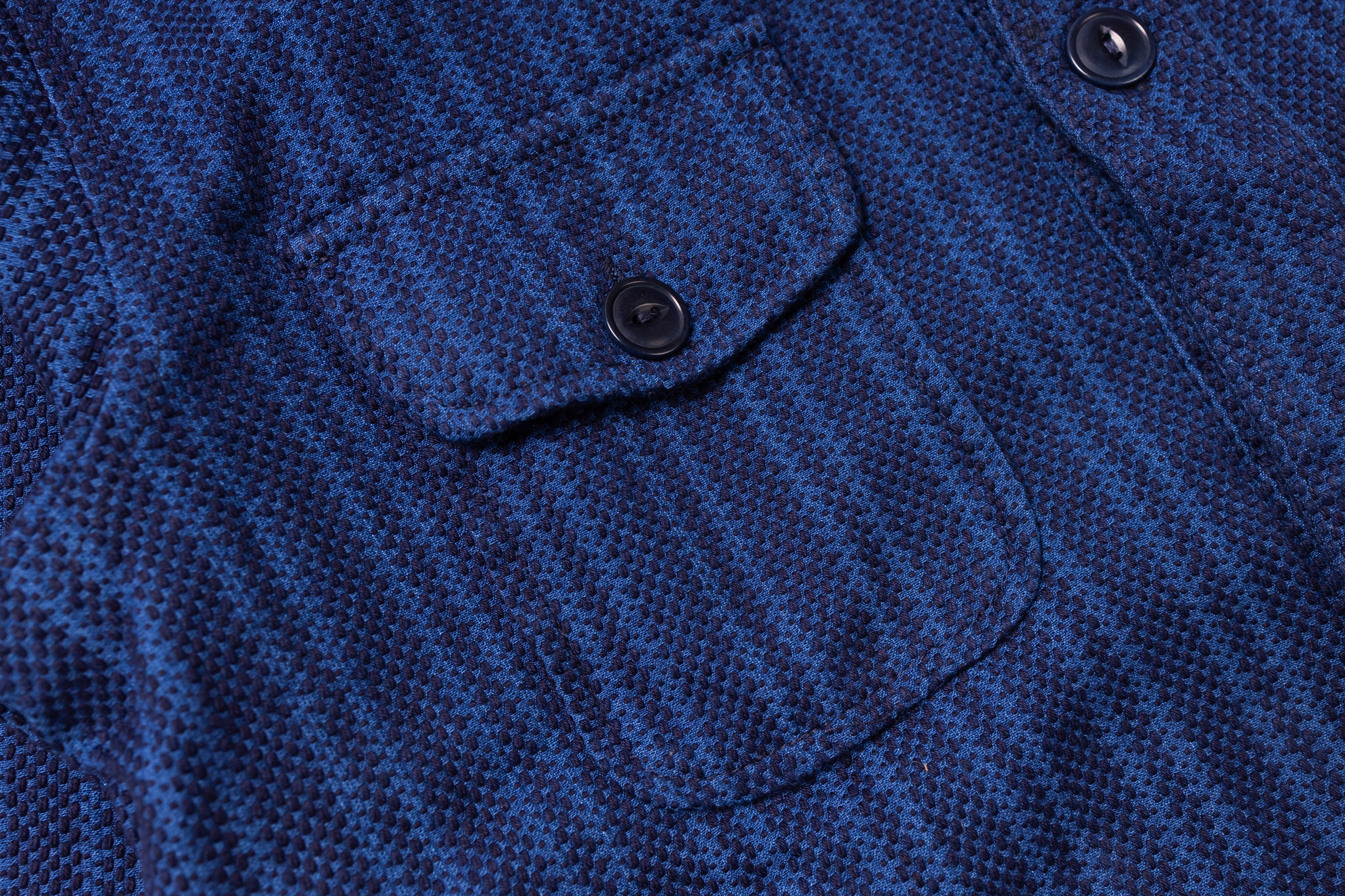 Close-up of a blue textured fabric with a button