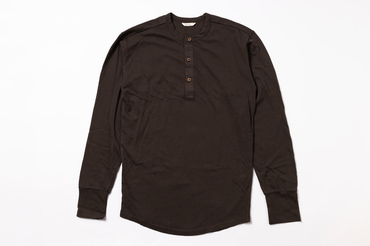 Brown long-sleeve shirt with buttons on a white background