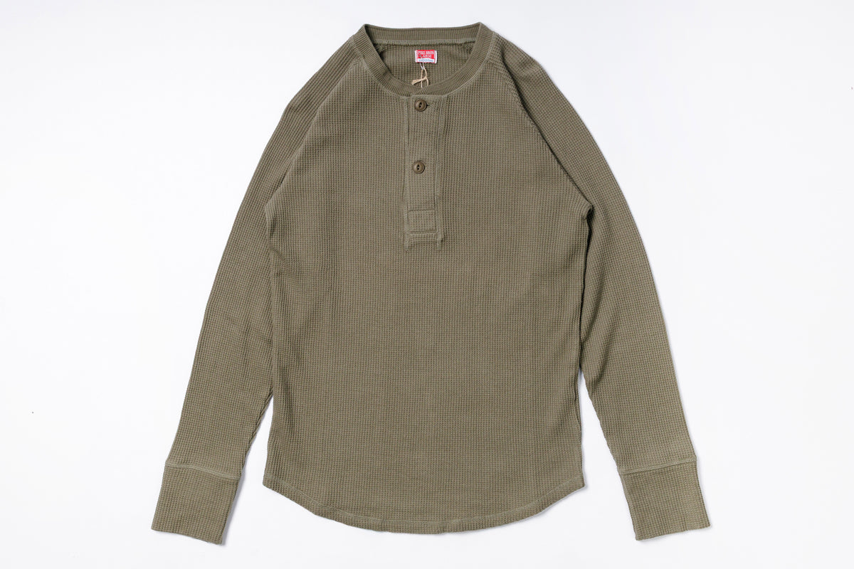 Green long-sleeve shirt on a white background