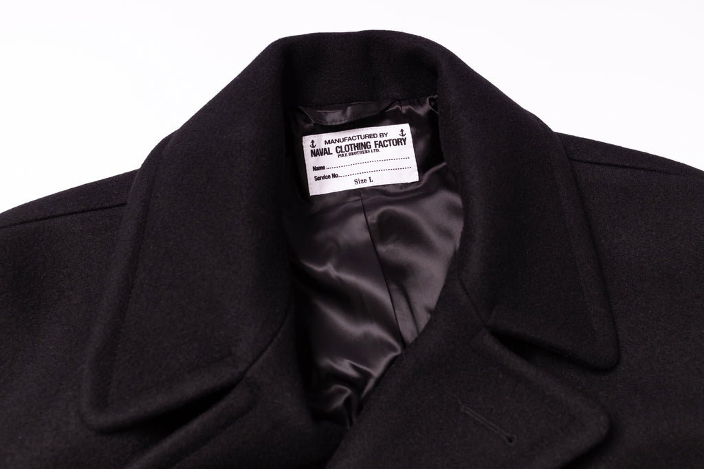 Black coat with a visible label on a white background