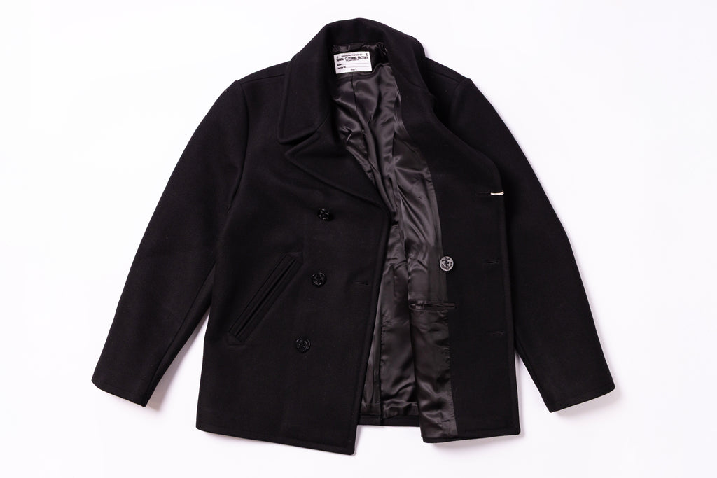 Black coat with a visible brand label on a white background