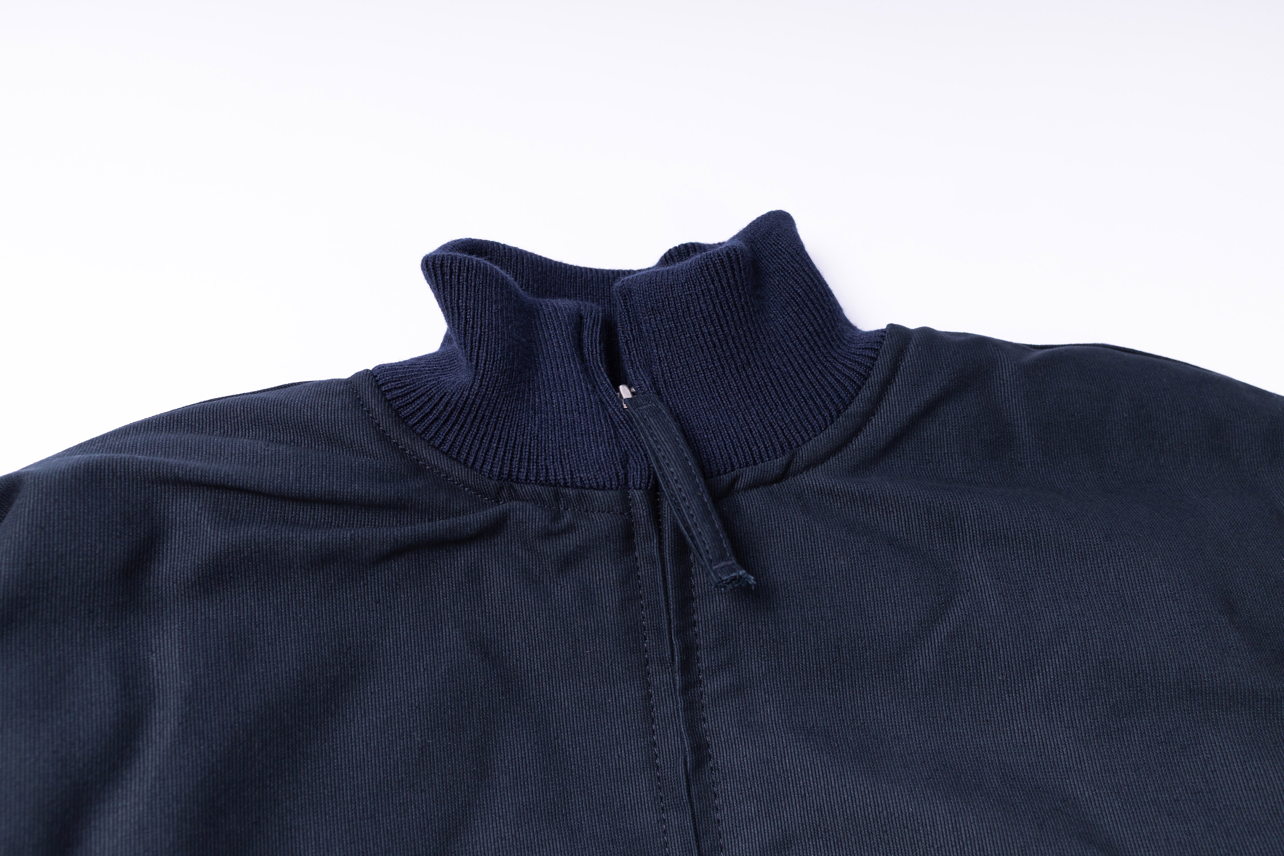 Navy blue jacket with a high collar on a white background