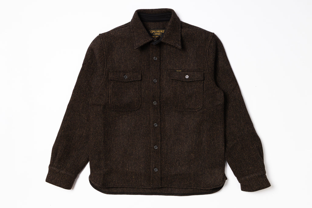 Brown shirt with button details on a white background