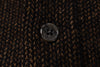 Close-up of a button on brown textured fabric