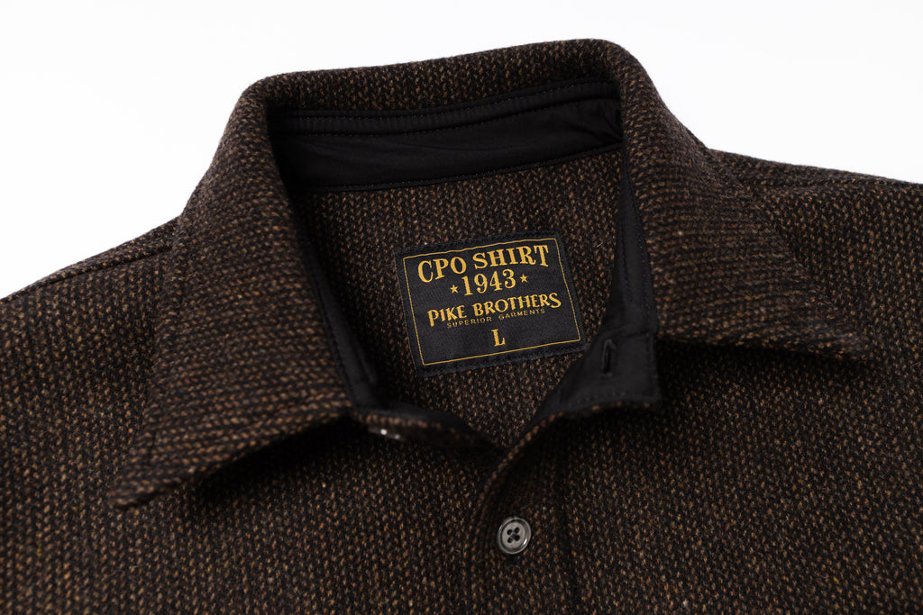 Brown textured shirt with a label on a white background