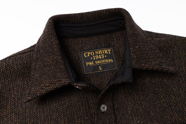 Brown textured shirt with a label on a white background