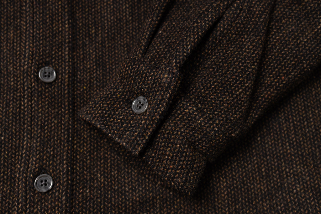 Close-up of a brown textured fabric with buttons