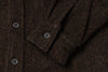 Close-up of a brown textured fabric with buttons