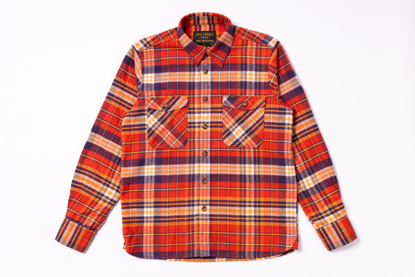 Plaid shirt with orange, red, and blue pattern on a white background