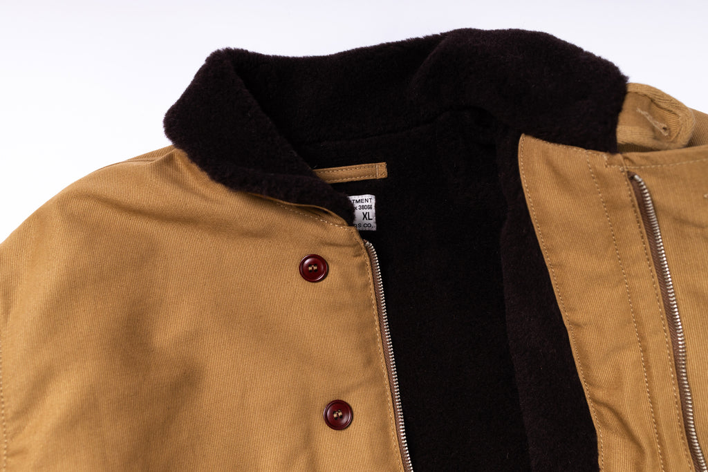 Close-up of a brown jacket with black collar on a white background