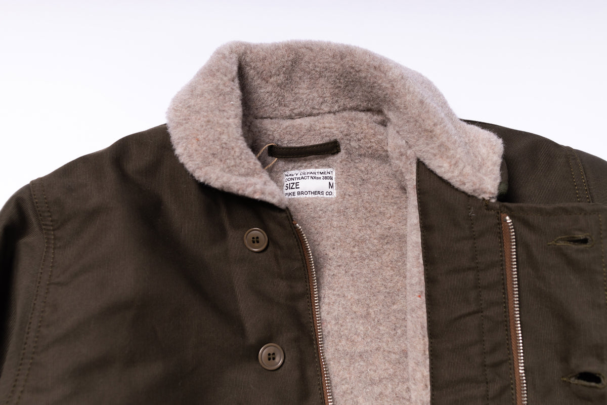 Brown jacket with beige sherpa lining on a white background