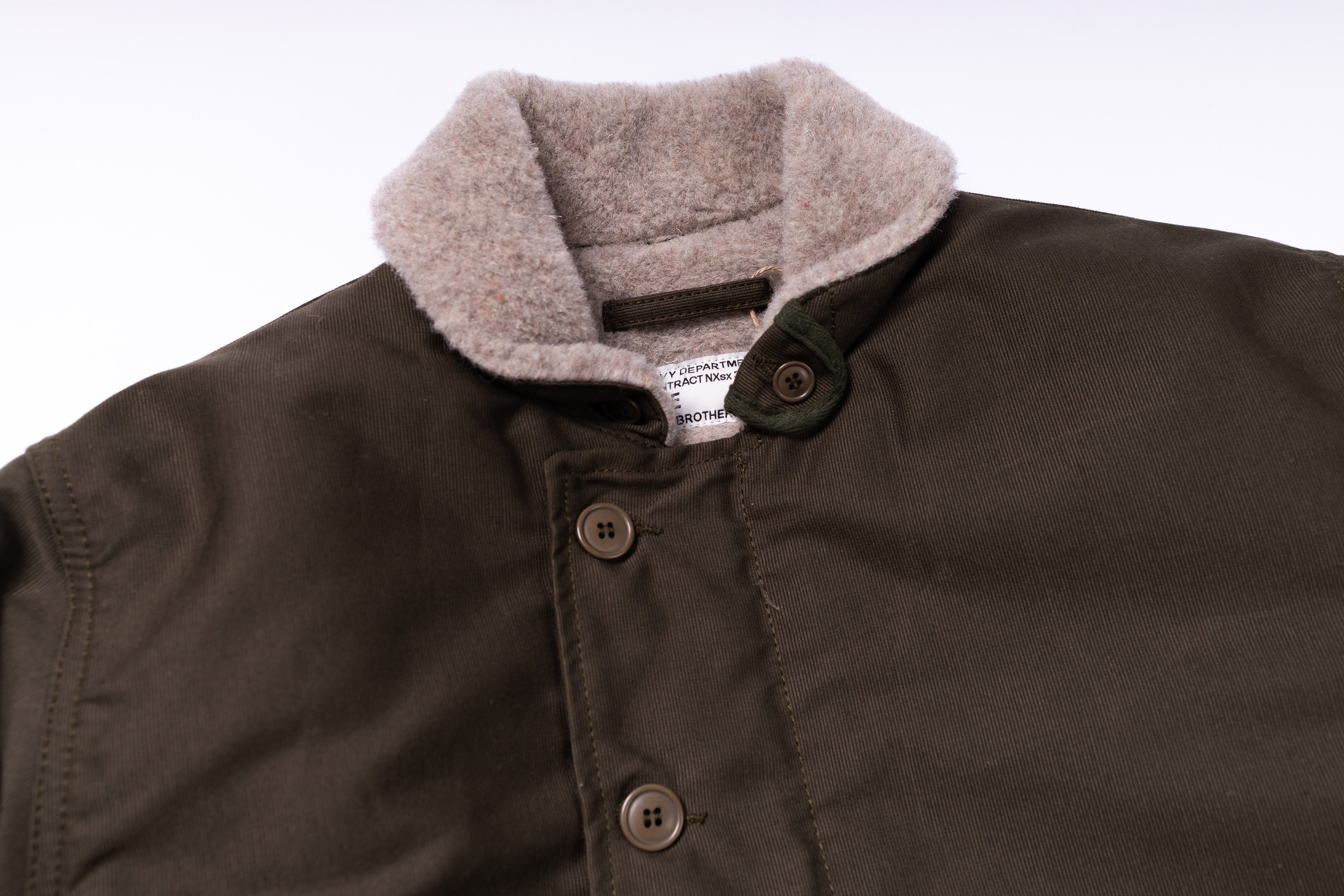 Brown jacket with gray fleece collar on a white background