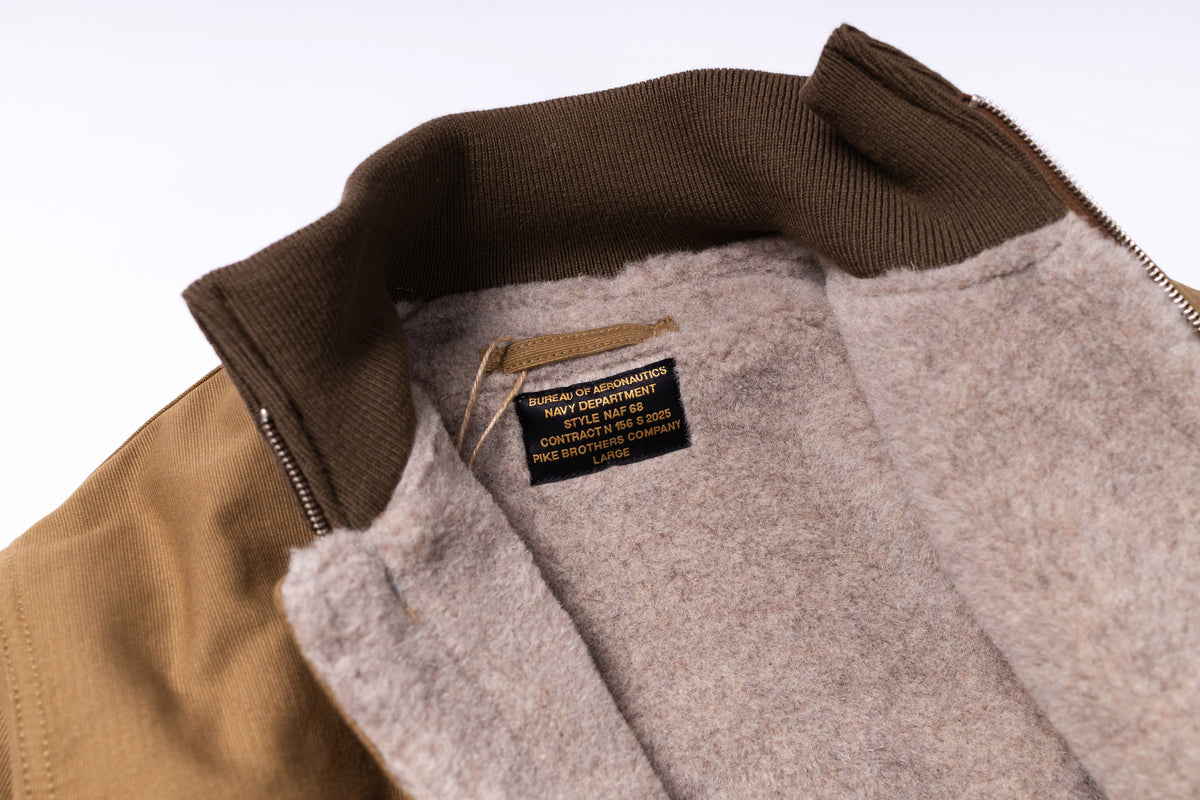 Close-up of a jacket with a brand label on a white background