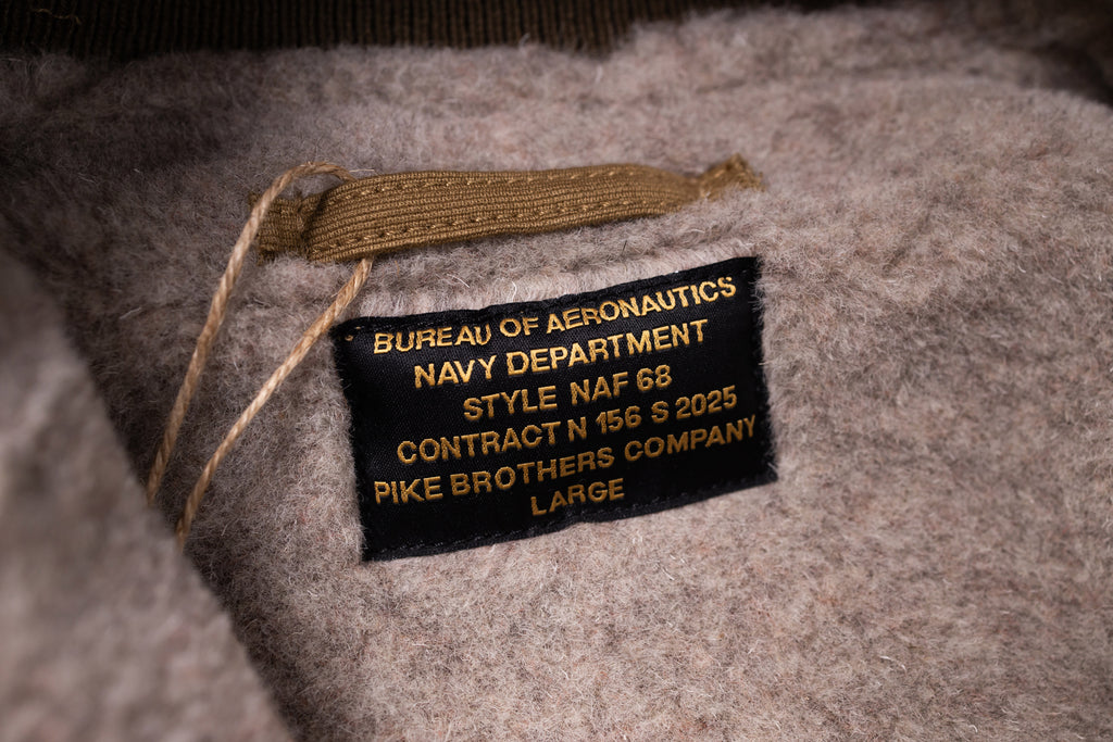 Label on a gray fabric surface with text detailing specifications.