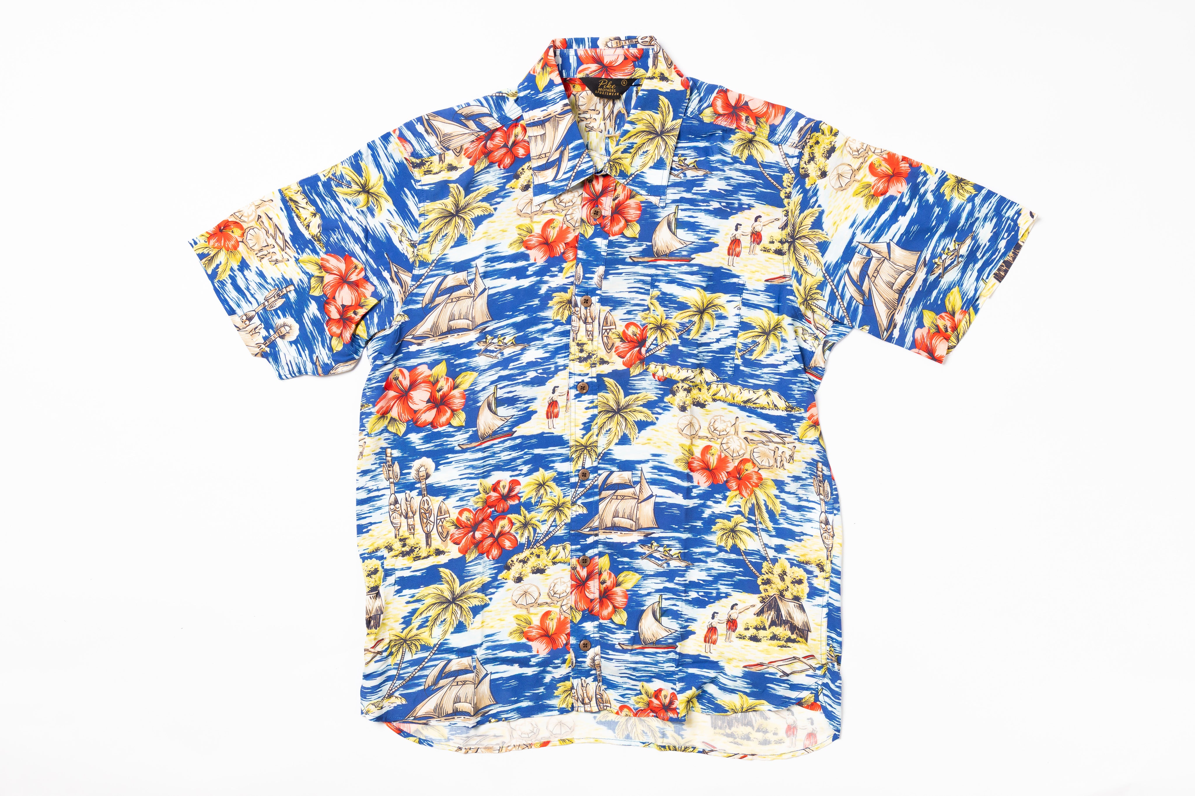 Colorful Hawaiian shirt with floral and ship design on a white background