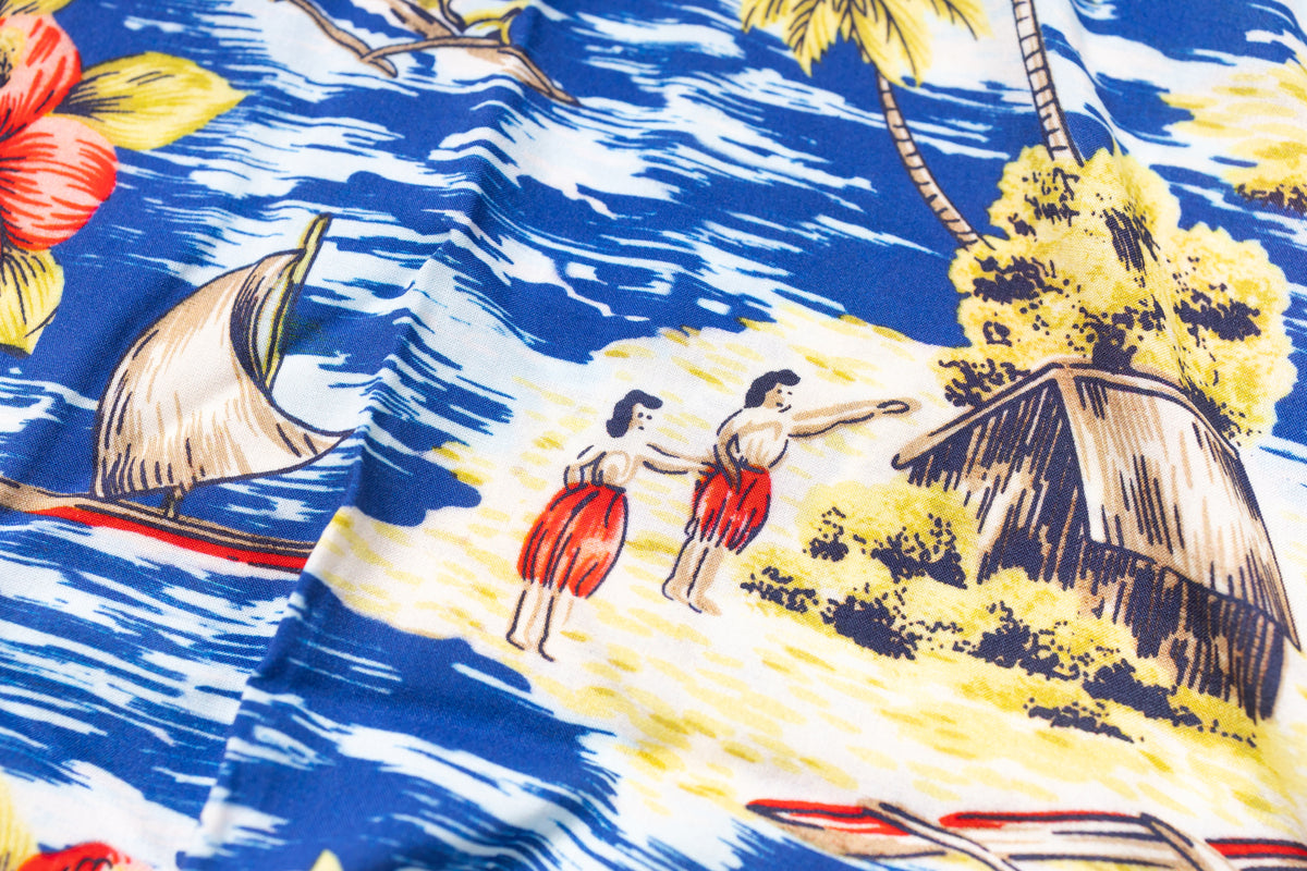 Fabric with tropical design featuring people, a hut, and sailboats.