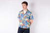 Man wearing a colorful floral shirt on a white background
